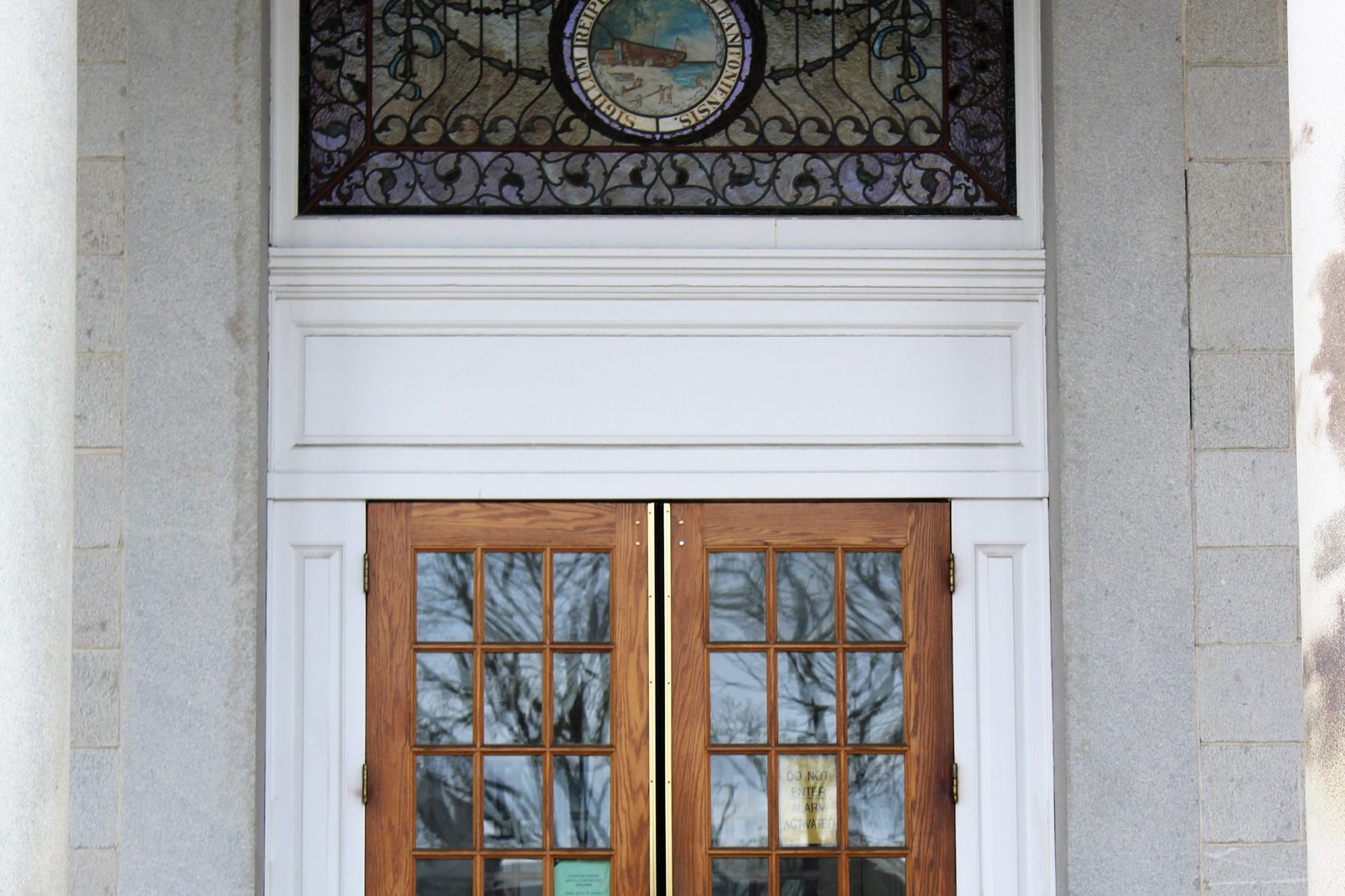 The columned entrance and eagle statue of the New Hampshire State House in Concord