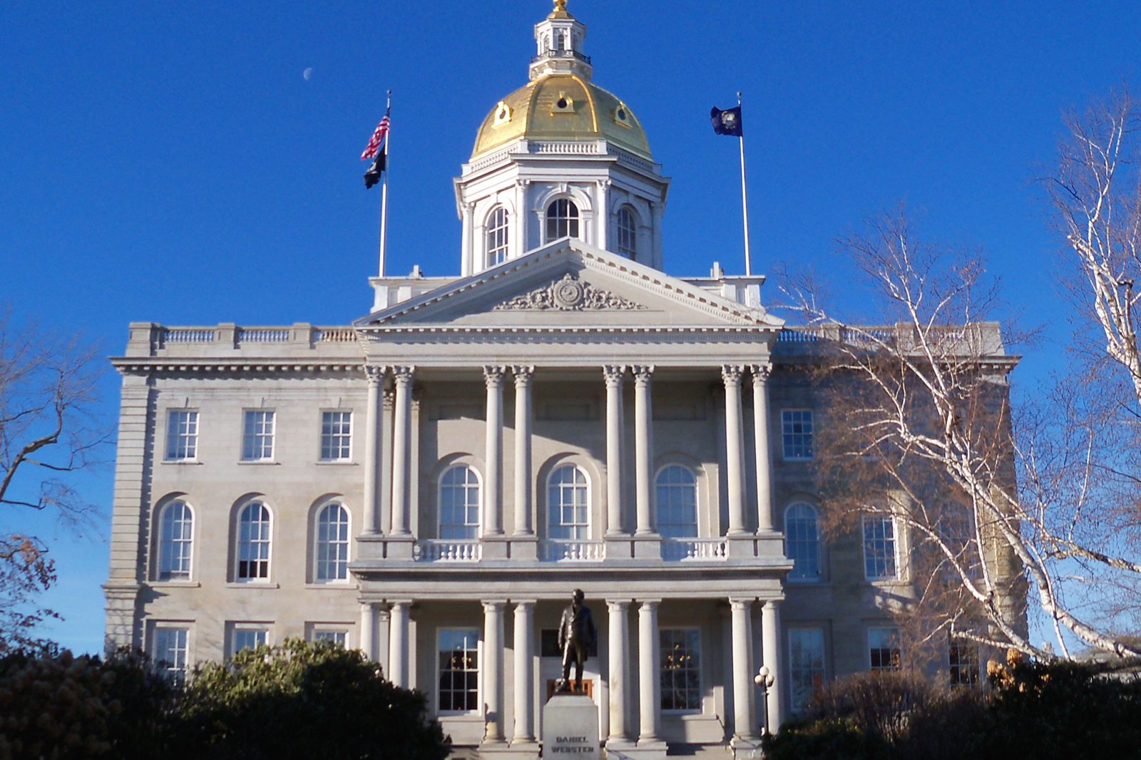 The New Hampshire State House in Concord, a stone building with a gold dome and a columned entrance