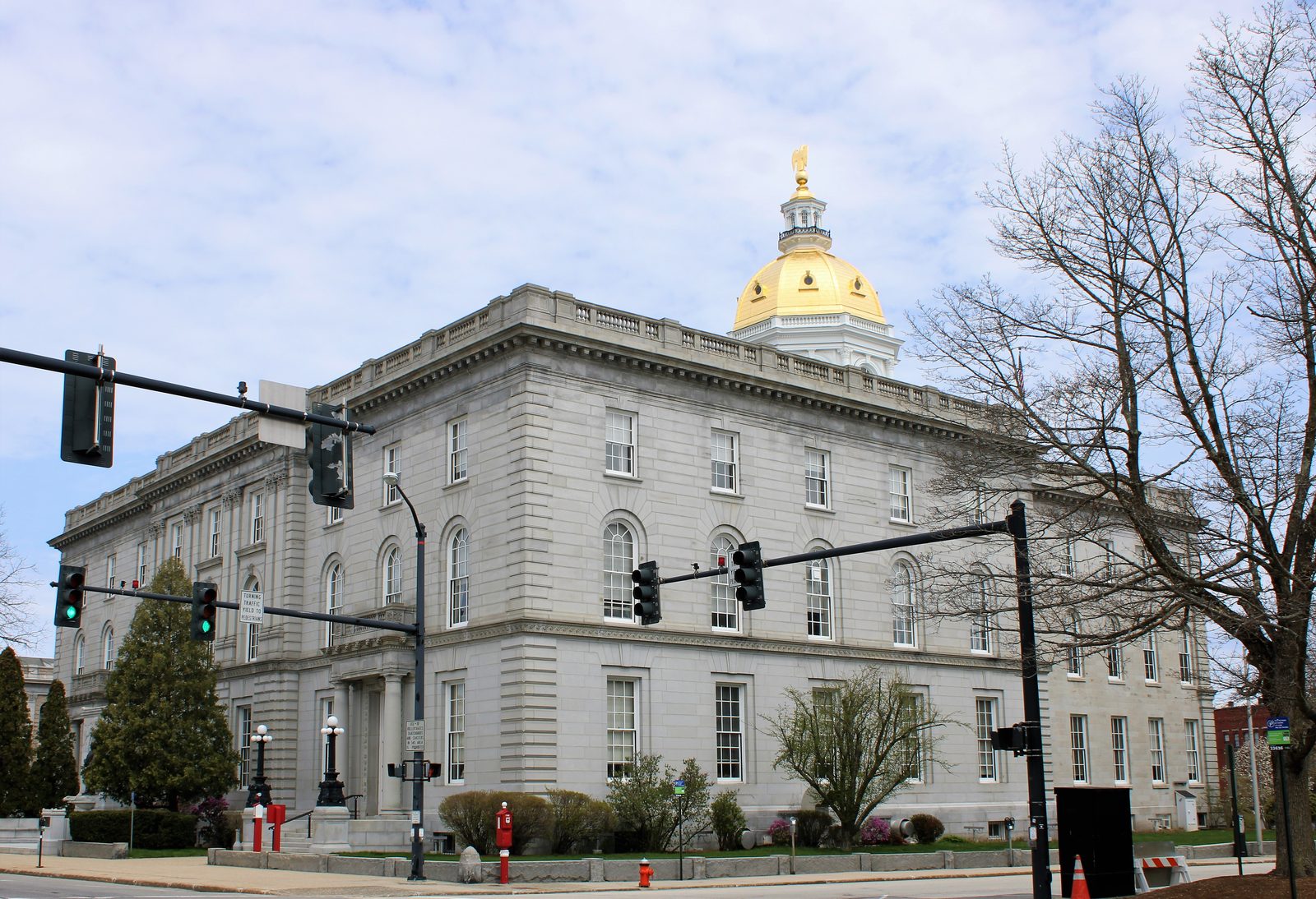 The New Hampshire State House in Concord, a granite building with a columned entrance and a gold dome