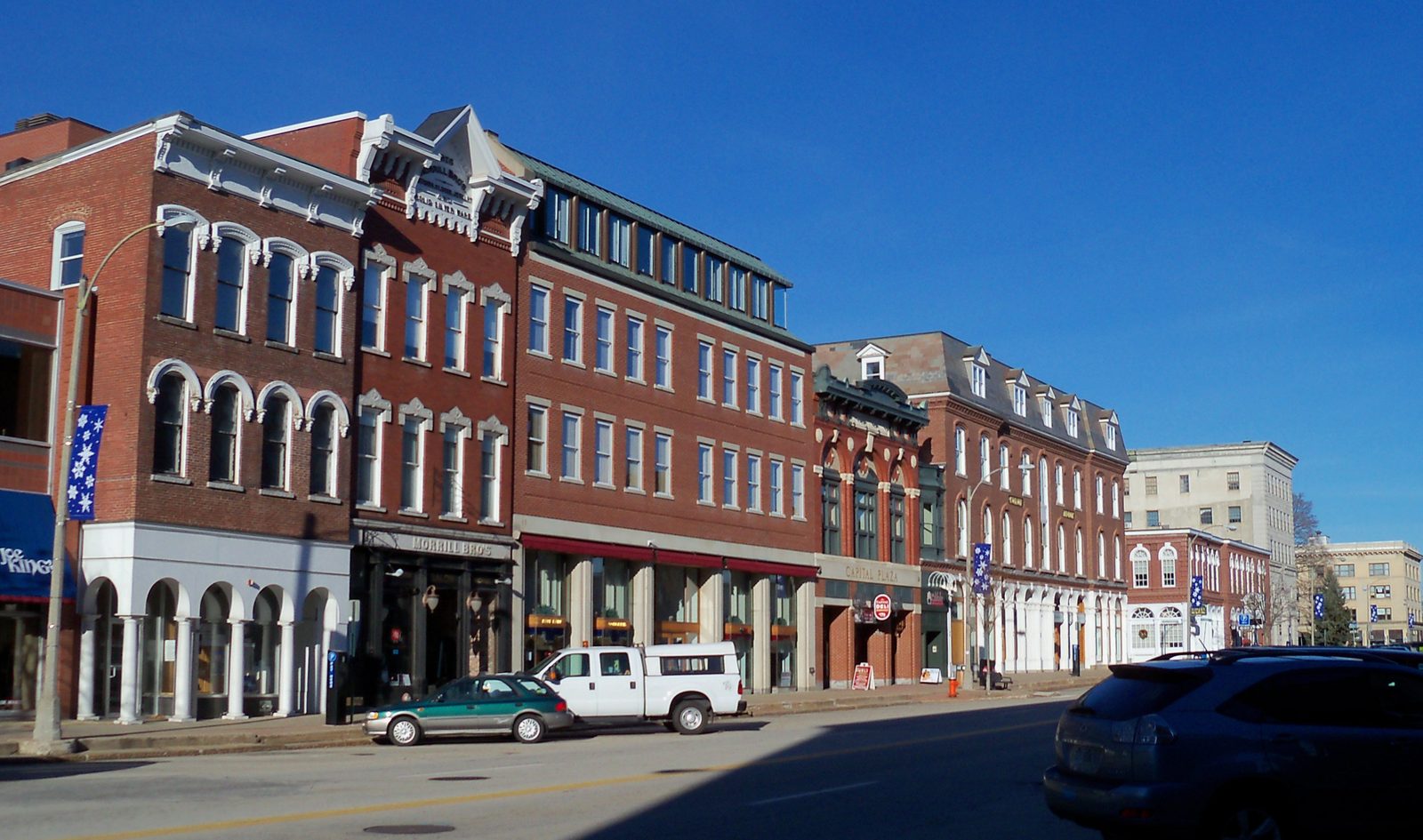 Main Street in downtown Concord, New Hampshire, with brick storefronts and a sidewalk clock