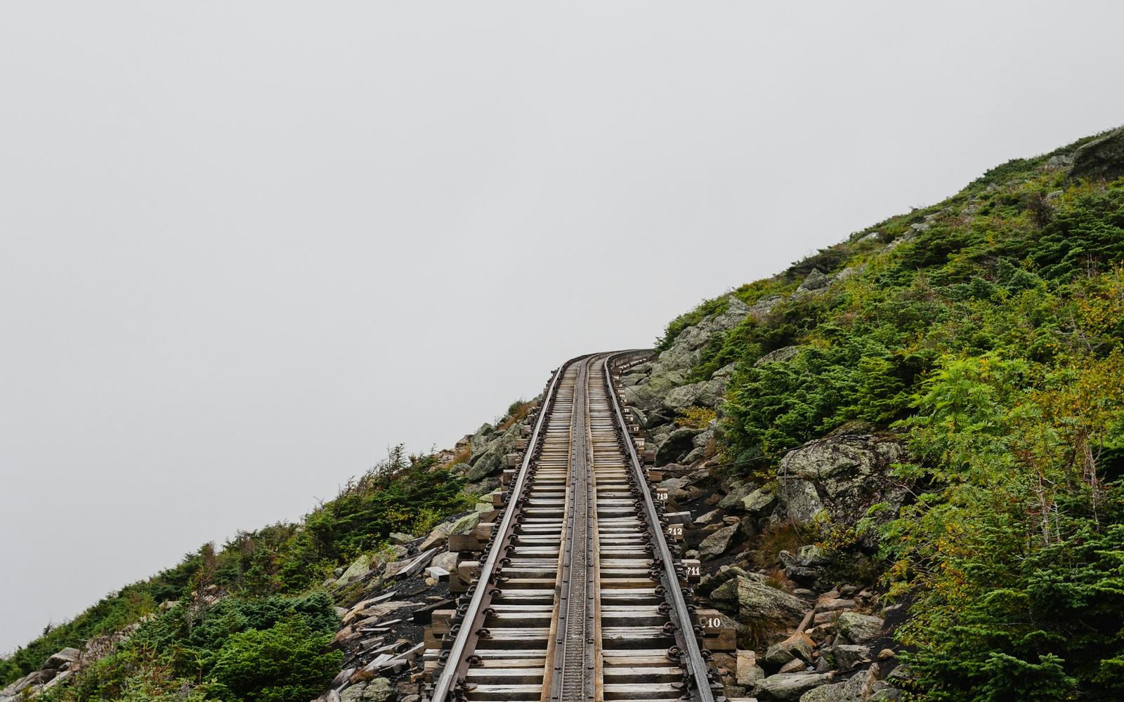 Cog railway tracks climbing Mount Washington into fog