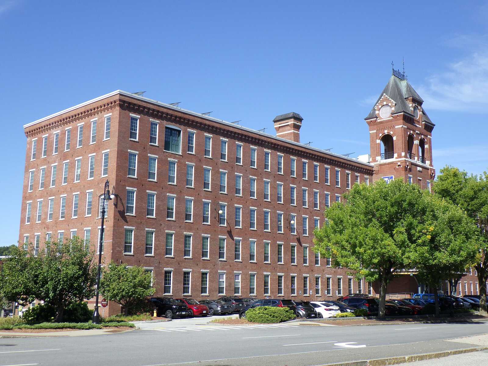 Red-brick mill building with a belfry on Commercial Street in Manchester