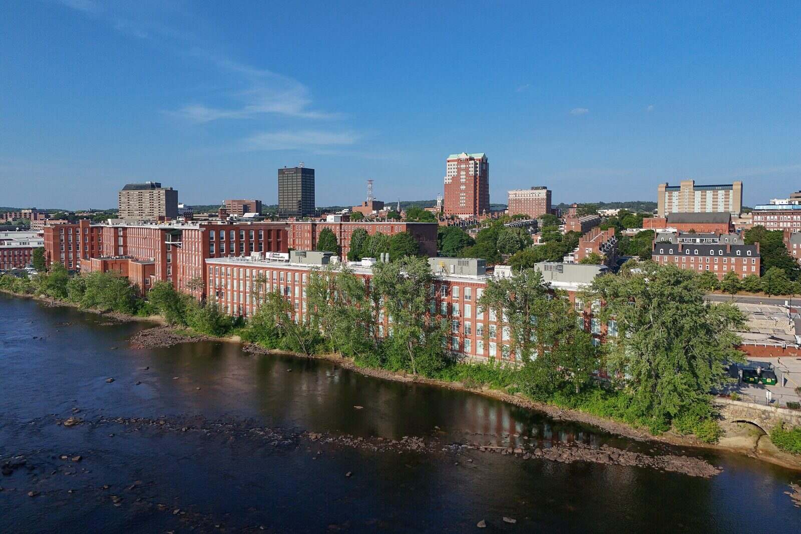 Amoskeag mills along the Merrimack River with downtown Manchester behind them