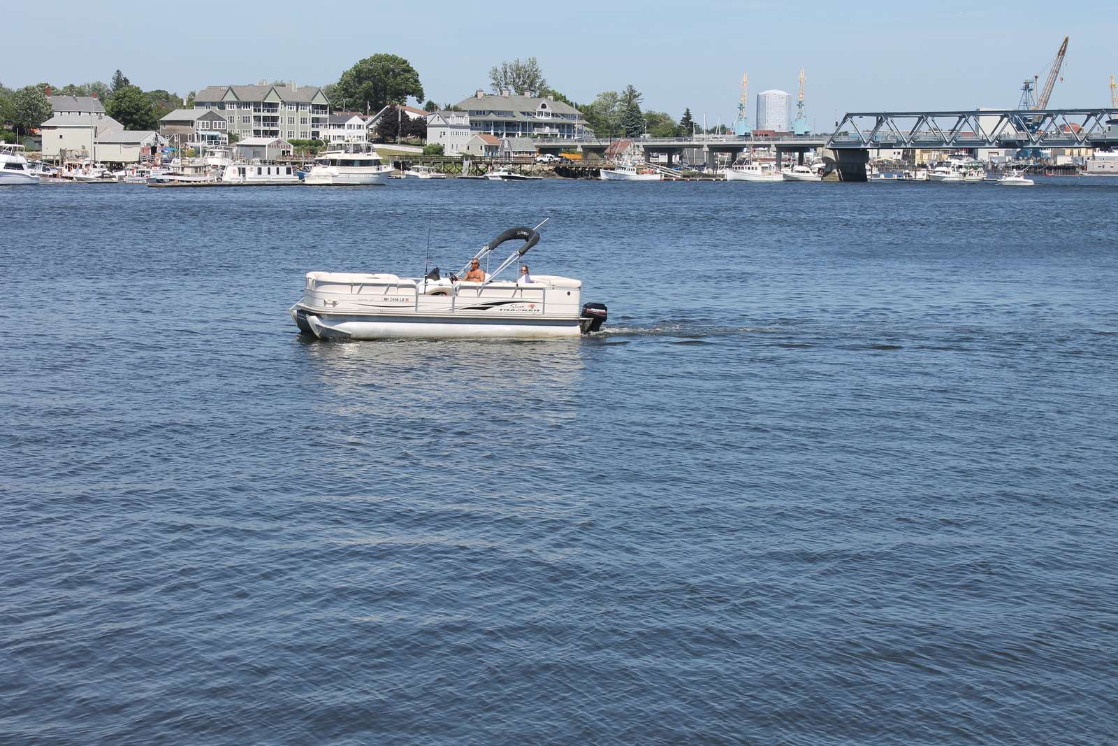 Pontoon boat on the Piscataqua with the Portsmouth waterfront behind it
