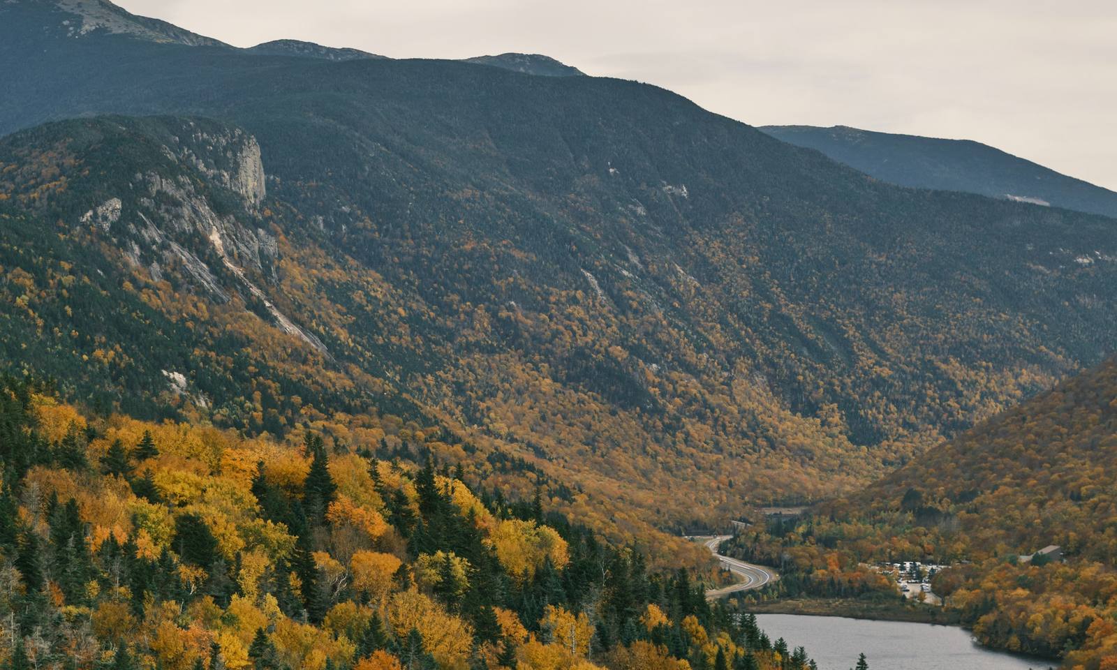 Fall color in a White Mountain valley, with a lake and a winding road